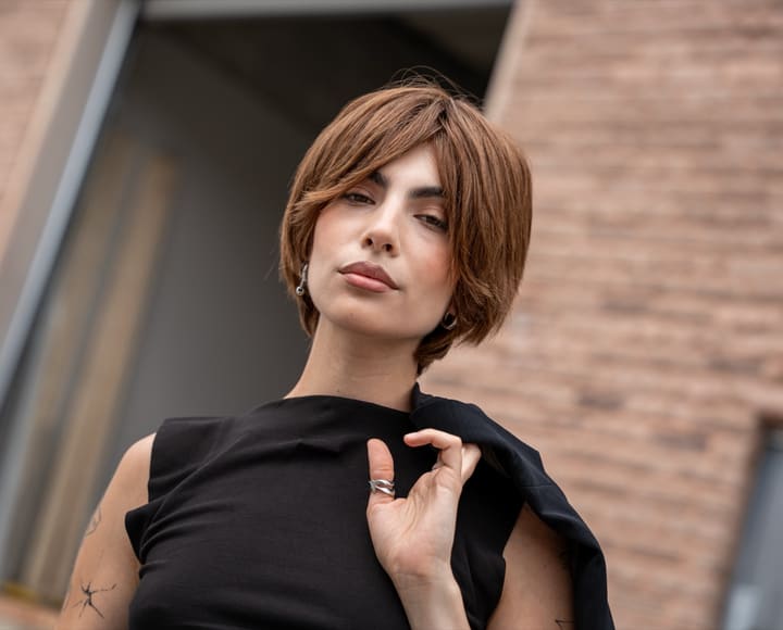 Model wearing the EUMET European virgin hair wig, styled bob with warm dimensional color