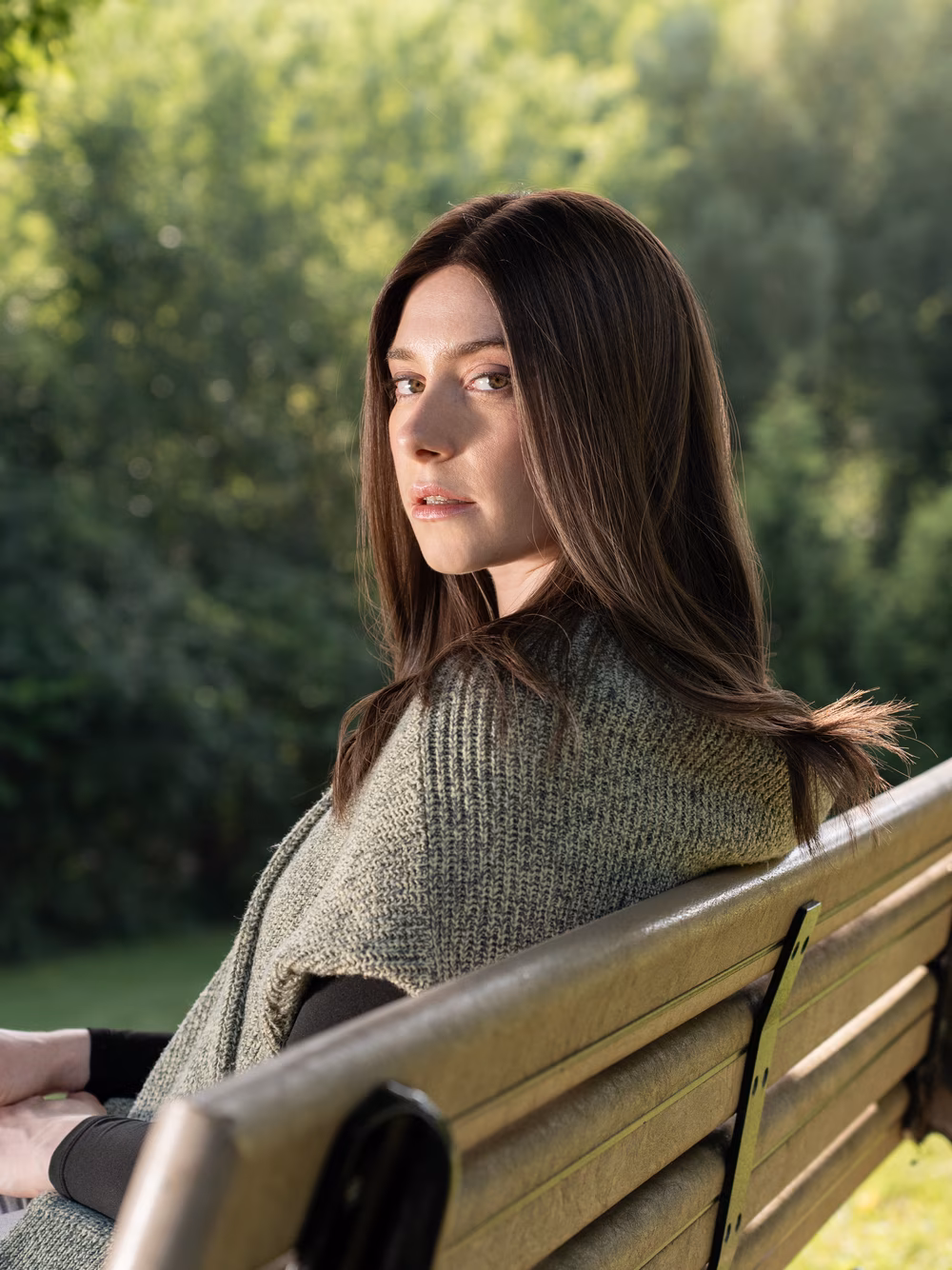 Esther kosher sheitel in Roasted Almond, side view on a park bench